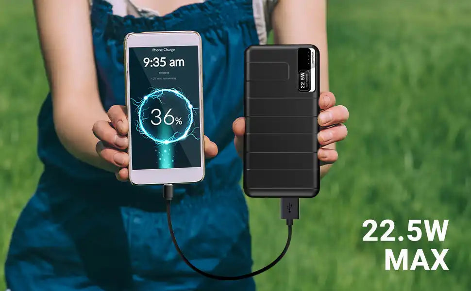 Portable power bank charging a smartphone displaying a 36% battery level indicator.